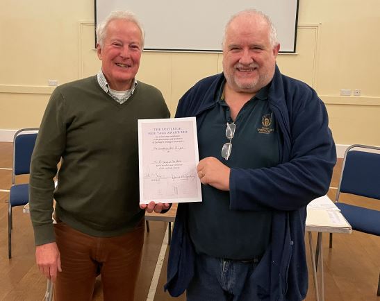 Tower Captain Rob Brown accepts the award from Lustleigh Society Chair, David McGahey